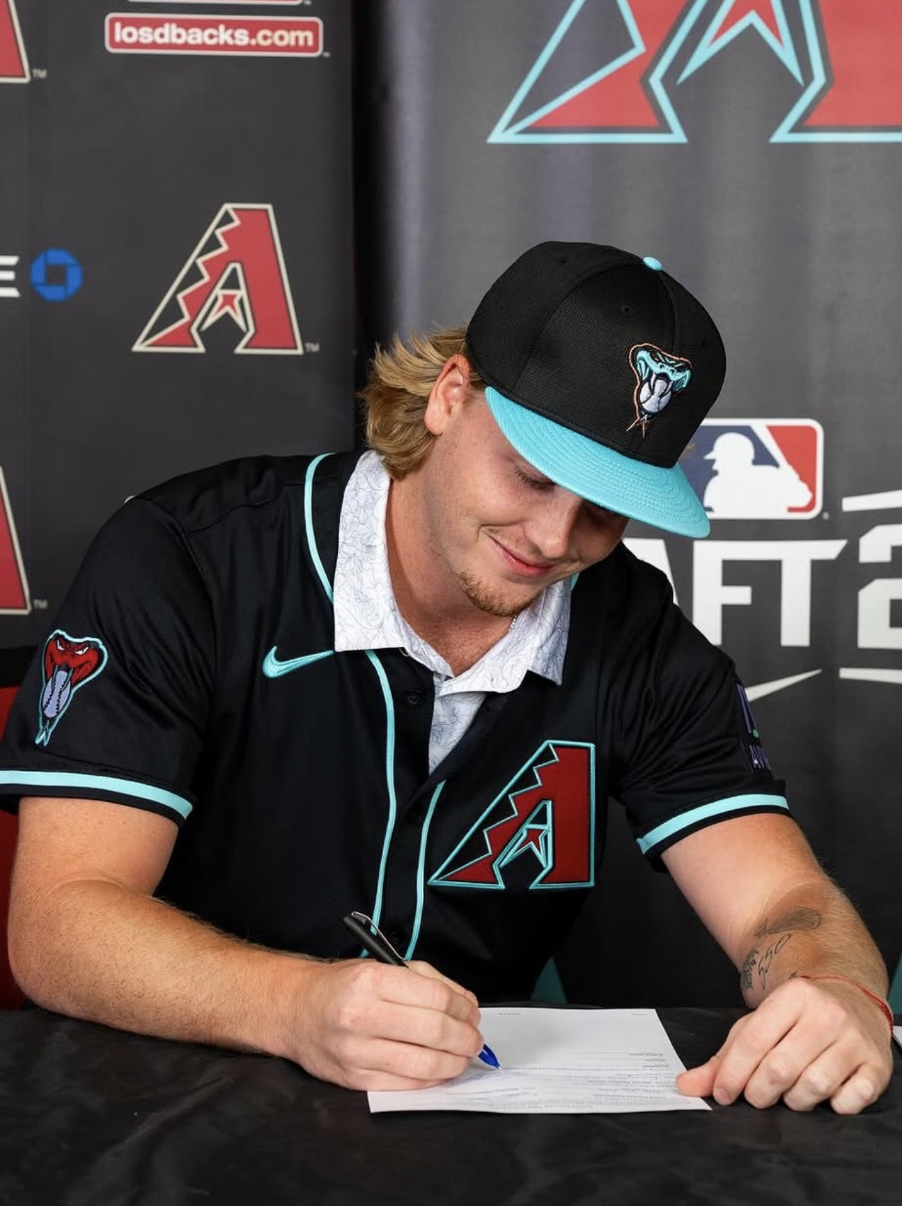 Sawyer, professional pitcher, signing his contract